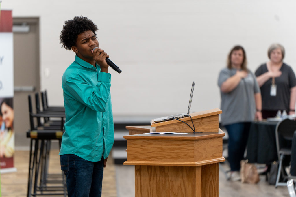 Micah Swain singing the national anthem. 